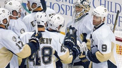 Marc-Andre Fleury is swarmed by his teammates after finishing the shutout of the Sabres.