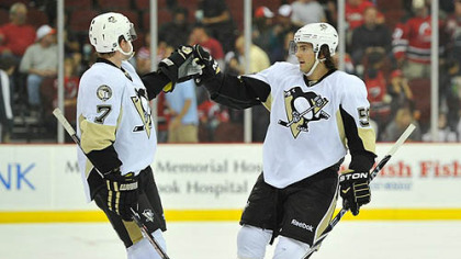 Penguins defenseman Paul Martin, left, is congratulated by Kris Letang after scoring an empty net goal during the third period.