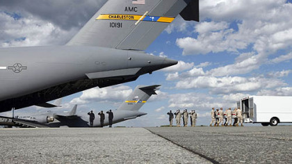 A Marine carry team carries a transfer case containing the remains of  Lance Cpl. Joshua T. Twigg, 21, of Indiana, Pa., Saturday, Sept. 4, 2010, at Dover Air Force Base, Del.
