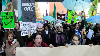 Protesters carried signs that expressed their opposition to gas-drilling operations.