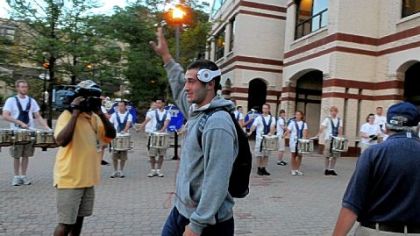Members of the Pitt Band drum line provided a rousing wake-up and send-off for the Panthers Tuesday morning as they left campus for practice at their South Side facility. Quarterback Tino Sunseri waves a thank you to the corps.