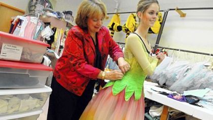 Janet Groom-Campbell, a costumier of the Pittsburgh Ballet Theatre, helps fit a costume on Danielle Downey.