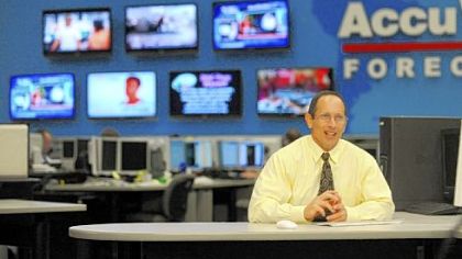 Meteorologist Joe Bastardi files a report from his desk at Accuweather's headquarters in State College on Wednesday.