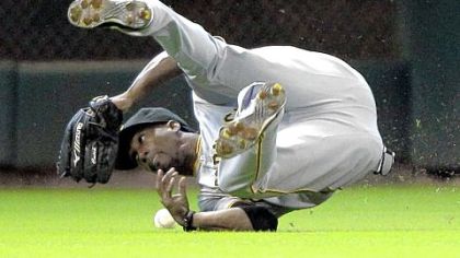 Pirates center fielder Andrew McCutchen tumbles while trying to catch a fly ball hit by the Astros' Jason Castro during the second inning yesterday's game in Houston. The Pirates lost 8-2.