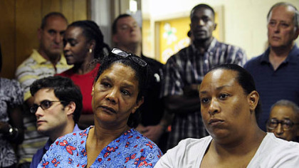 Concerned Braddock residents listen to members of council speak at an emergency meeting over missing funds.