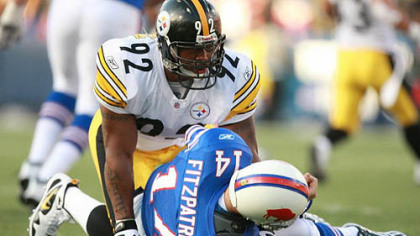 James Harrison rises after hitting quarterback Ryan Fitzpatrick of the Buffalo Bills during their Sunday in Buffalo. Harrison was flagged for roughing the passer during the play, and today learned he'll be fined $25,000 for the hit by the NFL.
