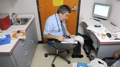 Matthew Levin sees a patient at his family practice office in Greensburg.