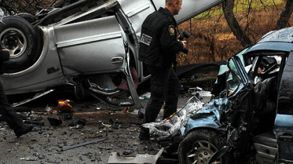 Pennsylvania State Trooper David Fries walks between the Ford F-150 and the Chrysler minivan to photograph the scene of the accident.