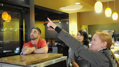 David Racicot, left, and Jennifer Jin, who will manage Racicot's new restaurant in Oakmont, listen as Jen Bee, right, explains some ideas she thinks will work in the front of the restaurant.