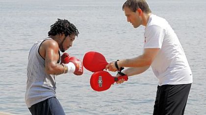 Monty Meza-Clay goes to work on the paddles wielded by head trainer Tom Yankello at a media session at the Rivers Casino August 20.