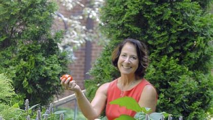 Judith Focareta, coordinator of environmental health initiatives at Magee-Womens Hospital, holds one of her favorite fruits from the garden, a 'Turkish Orange' eggplant. For a video of the hospital's gardens, go to post-gazette.com.