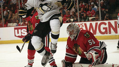 Penguins forward Max Talbot jumps to avoid a shot on Blackhawks goaltender Corey Crawford during the first period of tonight's game at the United Center in Chicago.