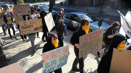 About two dozen people protested Steelers quarterback Ben Roethlisberger's return to the Steelers' lineup by marching from the National Aviary to Heinz Field.