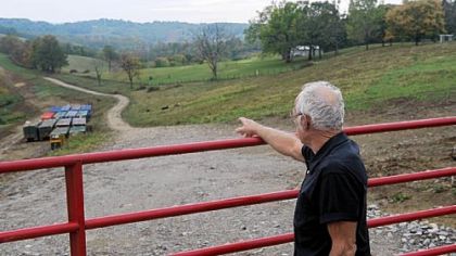 Taylorstown resident Thomas Westfall points to a pipeline buried under a strip of farmland.