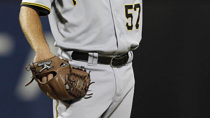 Pirates starting pitcher Zach Duke adjusts his hat after giving up a second-inning, two-run double to the Mets' Angel Pagan.