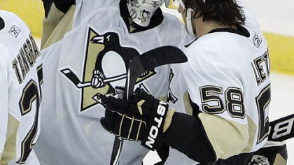 Penguins goaltender Brent Johnson is congratulated by defenseman Kris Letang after the Penguins defeated the Devils 3-1.