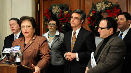 Flanked by Pittsburgh Controller Michael Lamb, left, and other council members, Pittsburgh City Council President Darlene Harris announces a plan that will avoid a state takeover of Pittsburgh's pension plan.