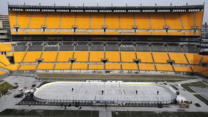 Workers prepare the ice rink at Heinz Field on Monday.