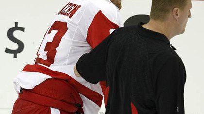 Red Wings forward Johan Franzen is helped off the ice after colliding with Penguins defenseman Brooks Orpik in the first period.