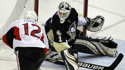 Penguins goaltender Brent Johnson blocks a shot by Senators forward Mike Fisher in the third period.