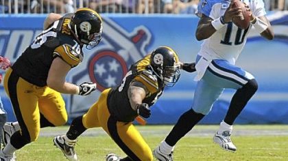 Chris Hoke, left, and LaMarr Woodley chase Tennessee quarterback Vince Young.