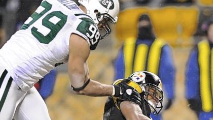 Jets' Jason Taylor throws Steelers' Mewelde Moore to the ground in the endzone for a safety in the fourth quarter.