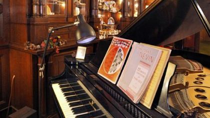 The music room in Alex Watson's North Lincoln St. home. Originally the home's dining room, the breakfront still dominates the room. The home will be on the Allegheny West Christmas House Tour.