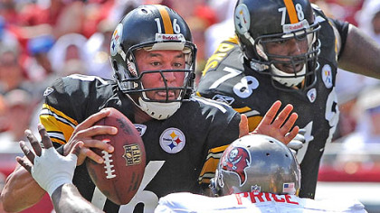 Charlie Batch breaks away from the grasp of the Buccaneers' Brian Price at Raymond James Stadium Sunday with Max Starks (78) protecting his left side.