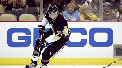 Penguins forward  Evgeni Malkin  handles the puck.