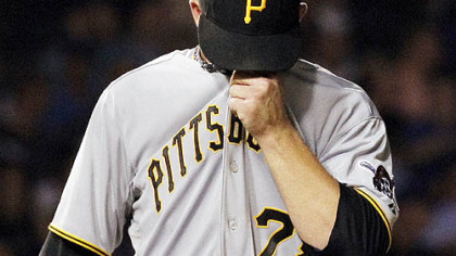 The Pirates' Paul Maholm wipes his face while pitching in the second inning of the 14-2 loss Monday at Wrigley Field.