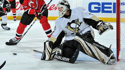 Devils forward Jason Arnott plays a rebounded shot on goal against Penguins goaltender Brent Johnson during the second period.