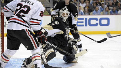 Penguins goaltender Brent Johnson makes a save against Blackhawks right wing Troy Brouwer during the first period.