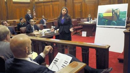 Cassidy Neal, of the Duquesne University mock trial team, explains to the "jury" in Courtroom 8B at the Federal Courthouse the dangers present in the hay baler, right, which allegedly caused serious injuries to her "client," a farmhand whose limbs were caught in the machinery.