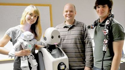 From left: CMU doctoral student Heather Knight with Little Toby, CMU Robotics Institute faculty member Paul E. Rybski with Snackbot and Robotics Institute lab assistant Austin Buchan with Uncle Sam.