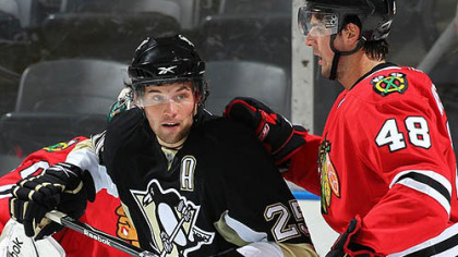 Blackhawks defenseman Simon Danis-Pepin battles with Penguins forward Eric Tangradi in a rookie tournament game Tuesday at the John Labatt Centre in London, Ont.