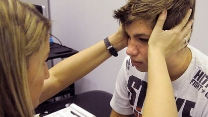 Physical therapy resident Pam Dunlap examines Gaige Pavlocak during an evaluation at the UPMC Sports Medicine Center on Pittsburgh's South Side. Gaige, a sophomore football player at Southmoreland High School, suffered a concussion in a preseason practice.