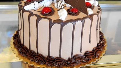 The Oakmonter cake at Oakmont Bakery is a layer of chocolate cake, cheesecake with a fudge center and milk chocolate buttercream icing.