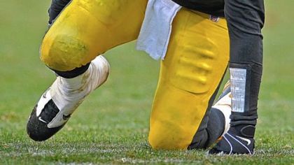 Steelers quarterback Ben Roethlisberger holds his ankle after being sacked by the Bengals at yesterday at Heinz Field.