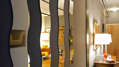 Mirrors in the hallway connecting the two rooms in loft A202 make it appear larger that it is. It was decorated by Mostly Mod.