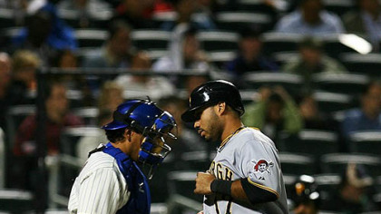 The Pirates' Pedro Alvarez scores a double hit by John Bowker in the fourth inning.