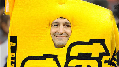 A Steelers fan dressed as the Terrible Towel cheers as the Steelers take the field against the Saints Sunday.