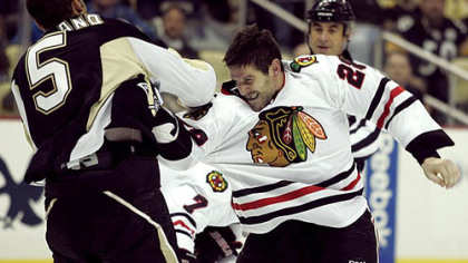 Blackhawks forward Jake Dowell fights Penguins defenseman Deryk Engelland.