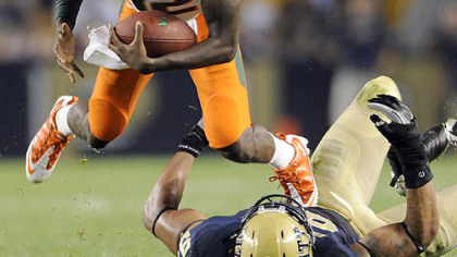 Miami quarterback Jacory Harris flies over Pitt defensive end Jabaal Sheard Thursday. Sheard called the Panthers' effort "embarrassing."