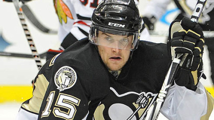 Penguins forward Dustin Jeffrey skates up ice.