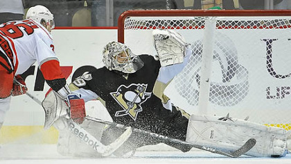 Penguins goaltender Marc-Andre Fleury makes a save on Hurricanes forward Jussi Jokinen during the shootout of Friday's game at Consol Energy Center.