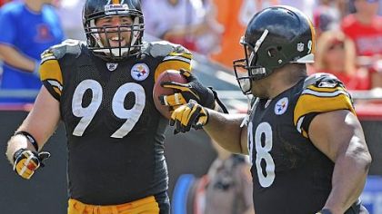 Defensive end Brett Keisel gets a congratulatory bump from Casey Hampton after Keisel returned an interception 79 yards for the Steelers' final touchdown of the game.