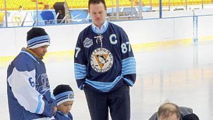 City Council members criticized Mayor Luke Ravenstahl for attending a promotional event on Tuesday instead of meeting with council members about the pension crisis. At the event, the mayor, center, watches youth hockey players A'sShon Burgess, left, 12, of Washington, Pa.; Ian Banks, 11, of Penn Hills; and Janelle Wakevicus, 8, of Brentwood help NHL facilities operations manager Dan Craig paint the net area on the hockey rink built in Heinz Field for the Winter Classic.